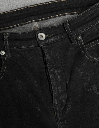 Close-up of black denim jeans with stitching details
