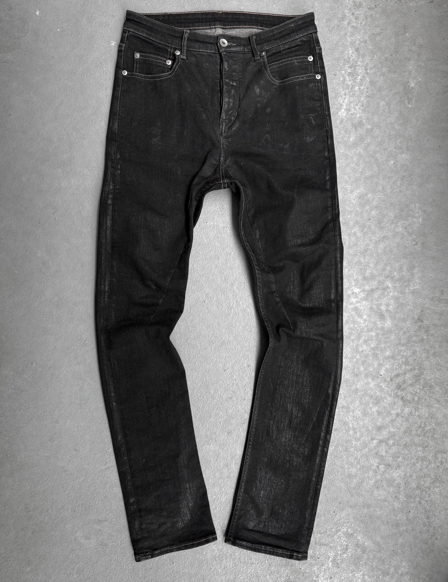 Black jeans on a gray textured background