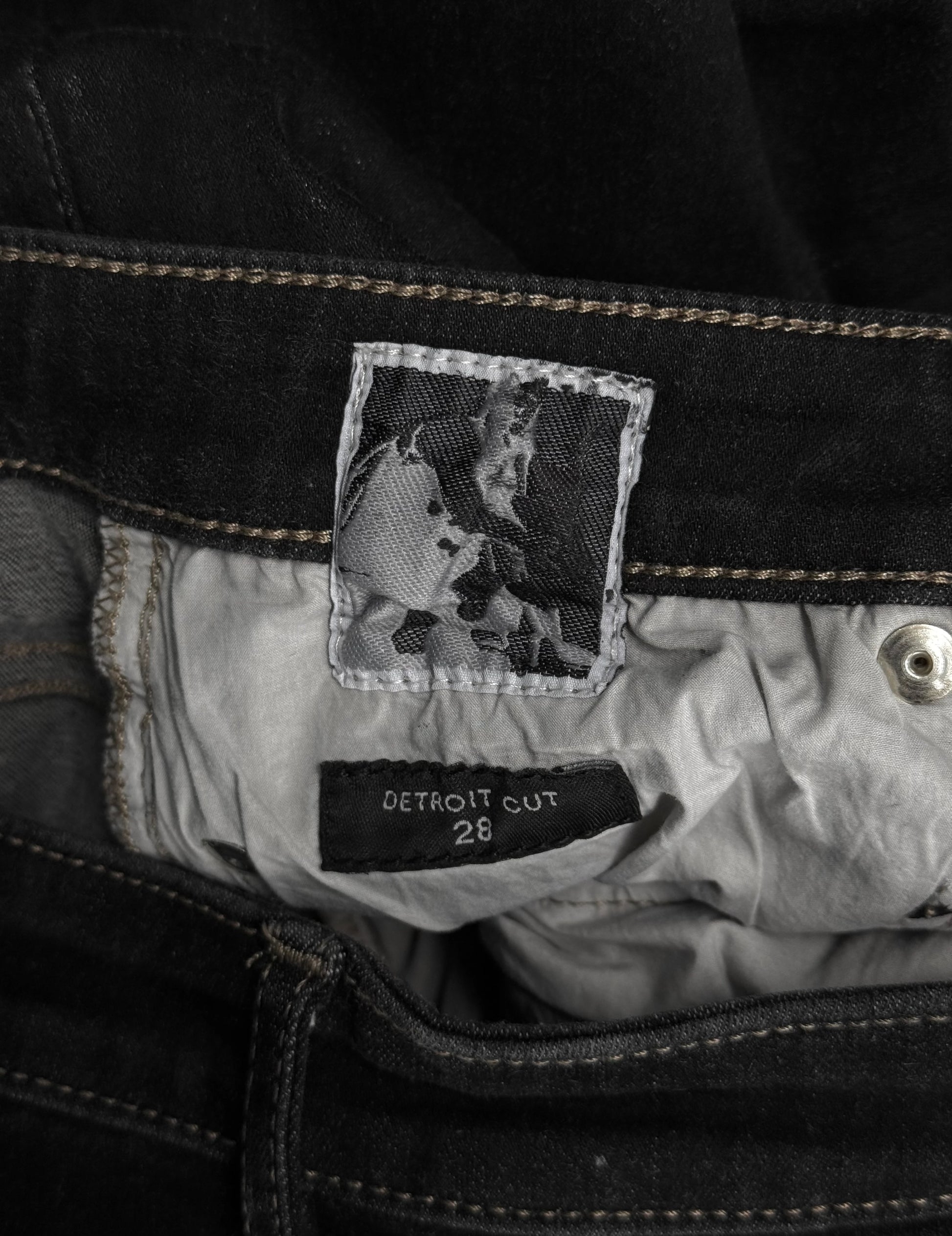 Close-up of a label on a jacket with a black and white photo and text.