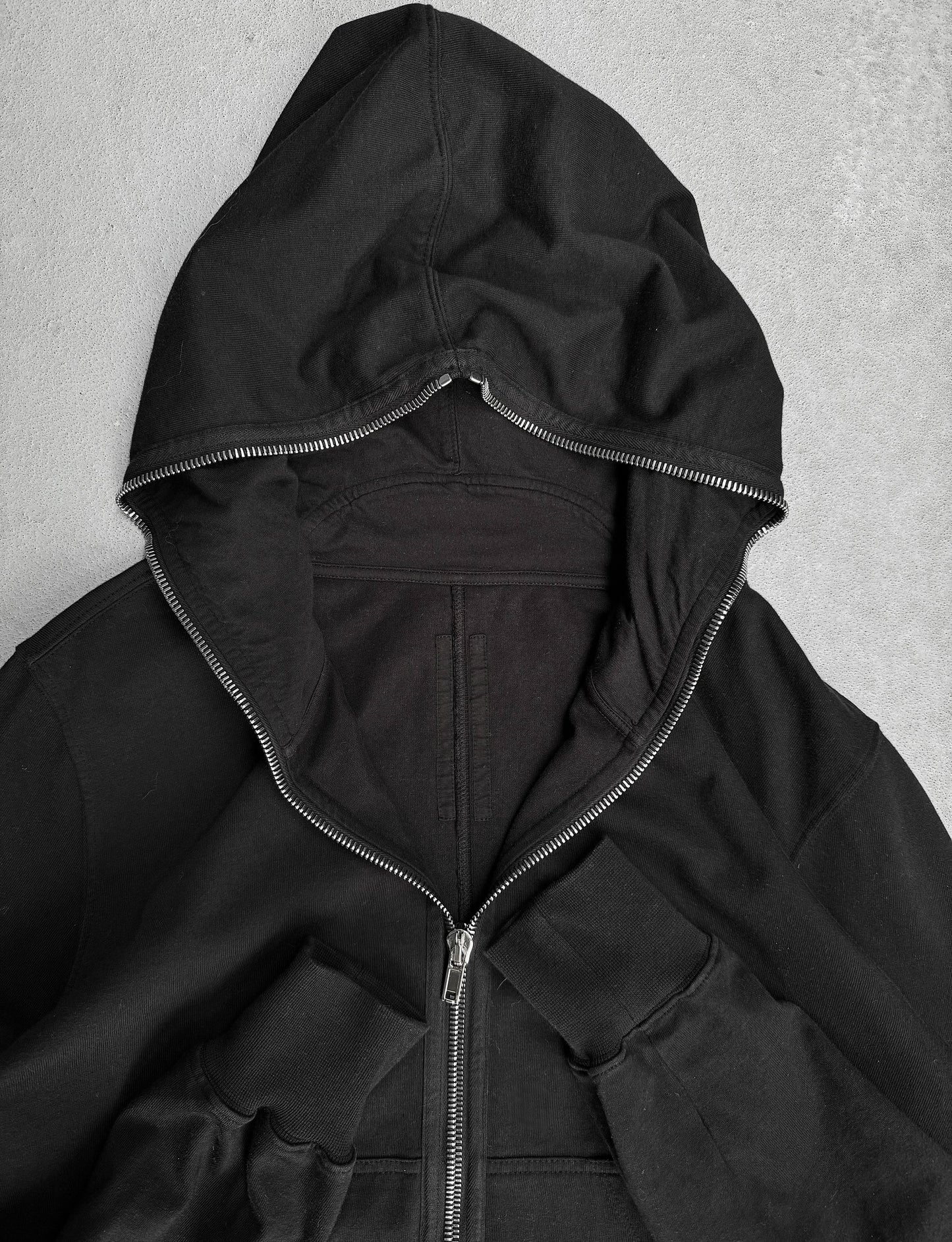 Black hooded jacket on a gray background
