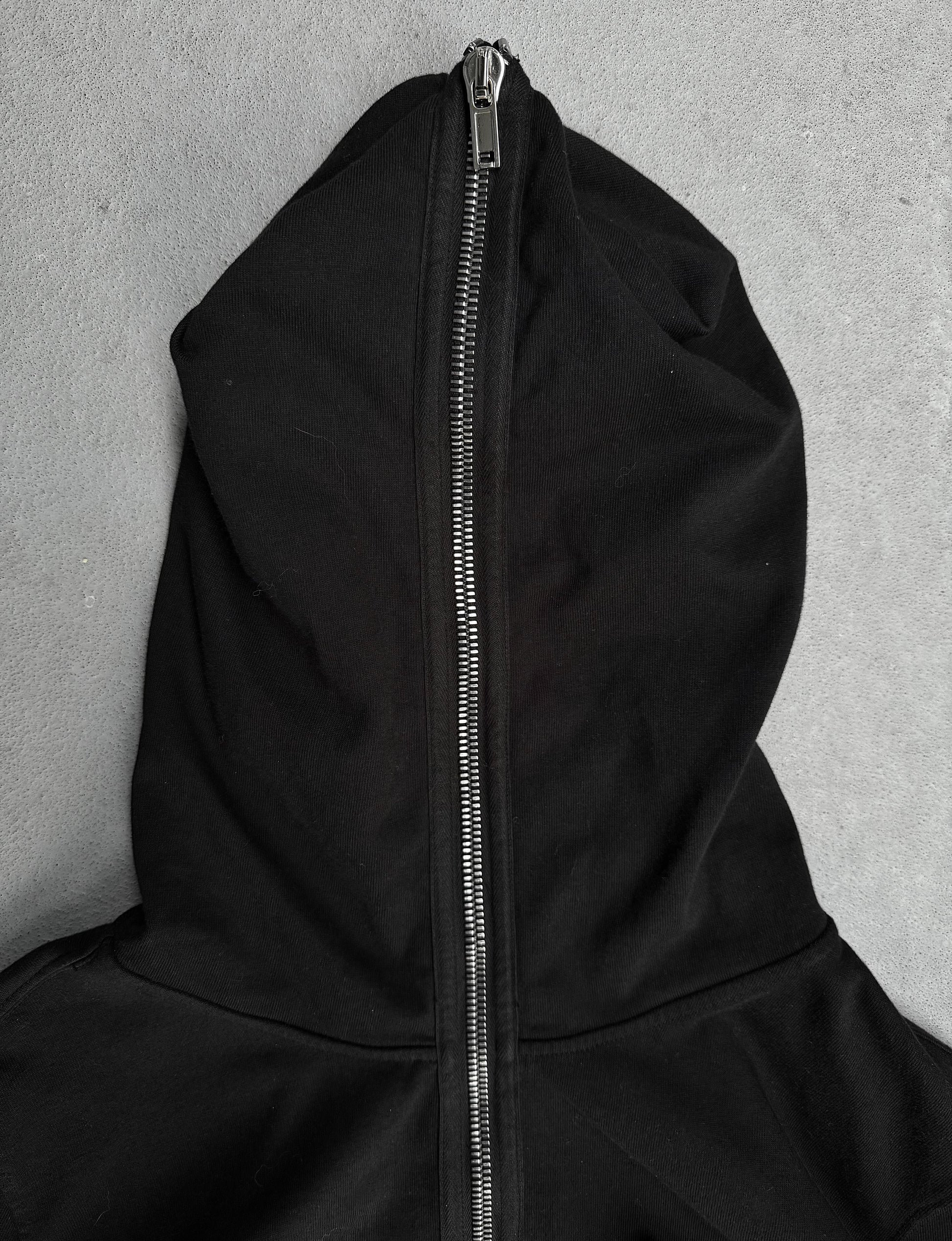 Black hoodie with a zipper on a gray background