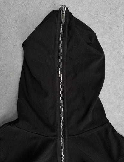 Black hoodie with a zipper on a gray background