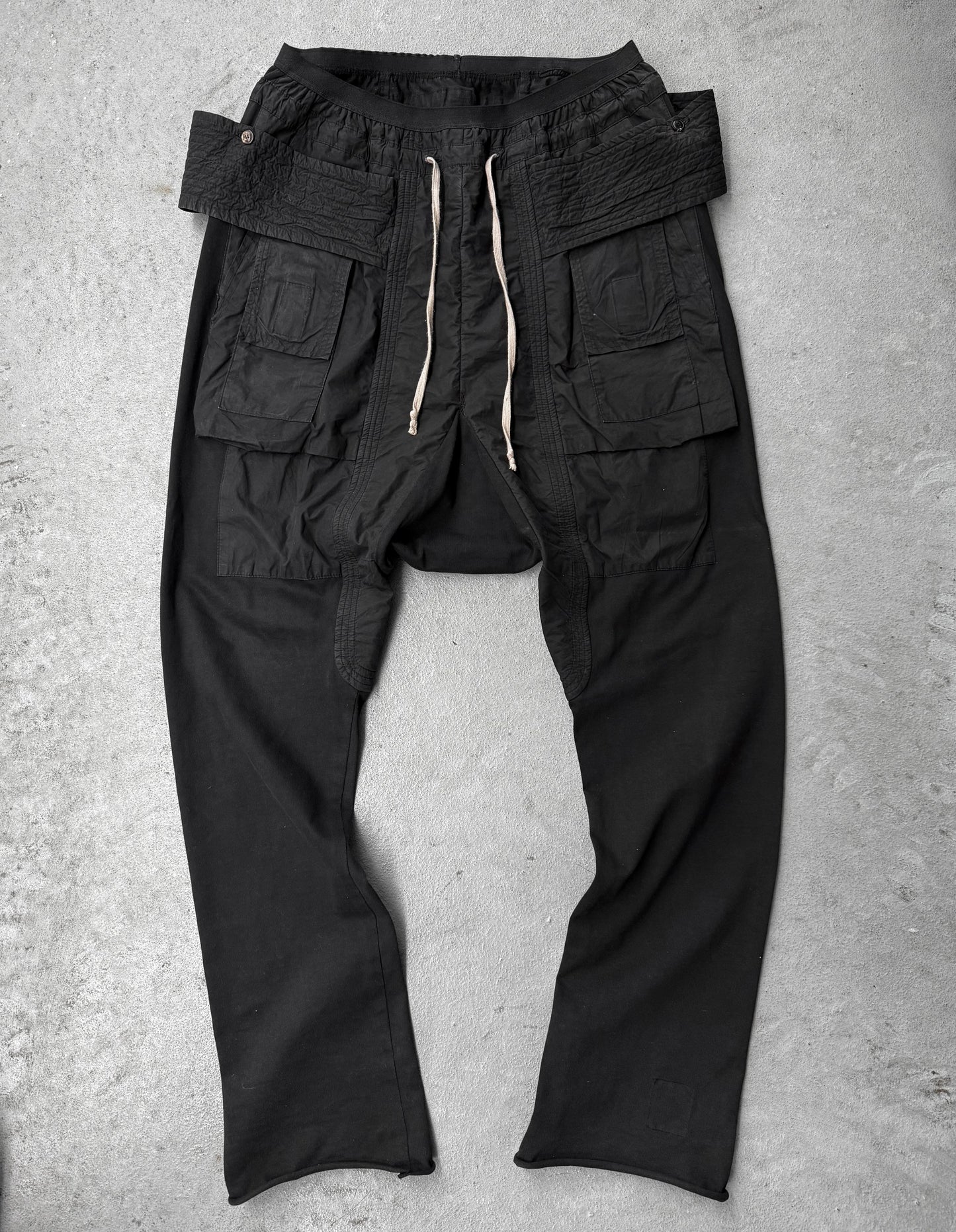 Black cargo pants on a gray concrete surface