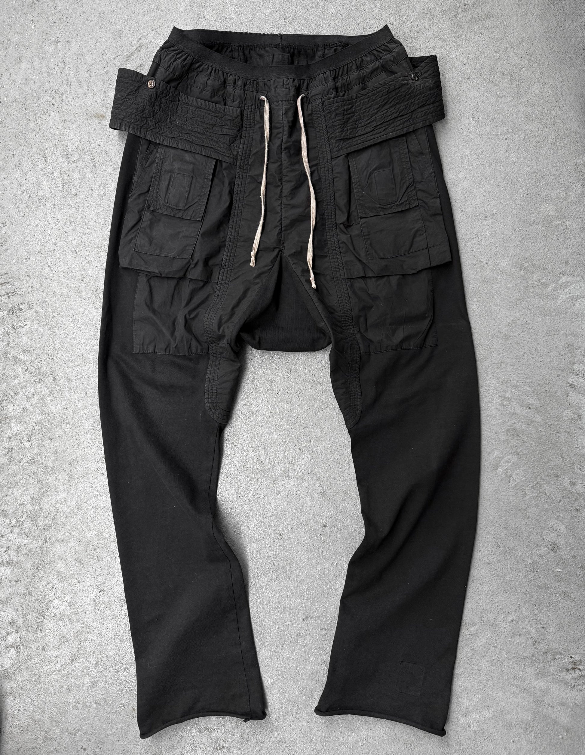 Black cargo pants on a gray concrete surface