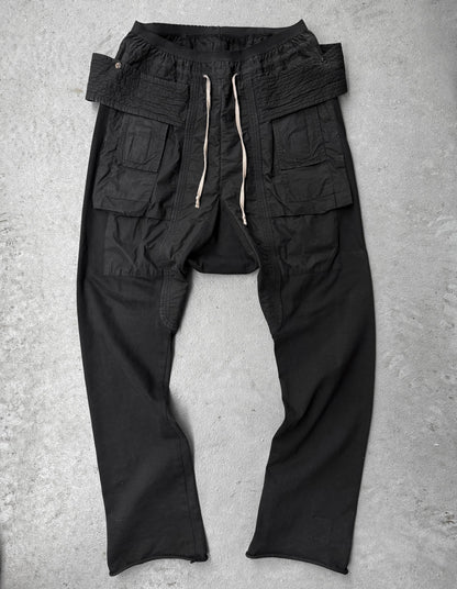 Black cargo pants on a gray concrete surface