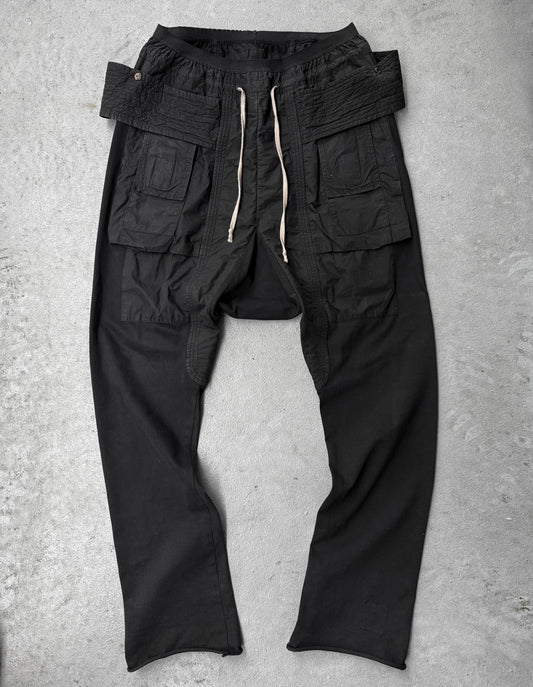 Black cargo pants on a gray concrete surface
