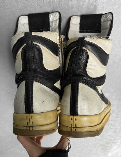 Pair of white sneakers with black accents on a gray background