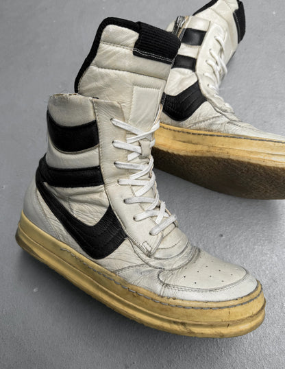 White high-top sneakers with black accents on a gray surface