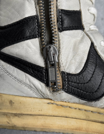 Close-up of a vintage sneaker with a zipper and leather accents.