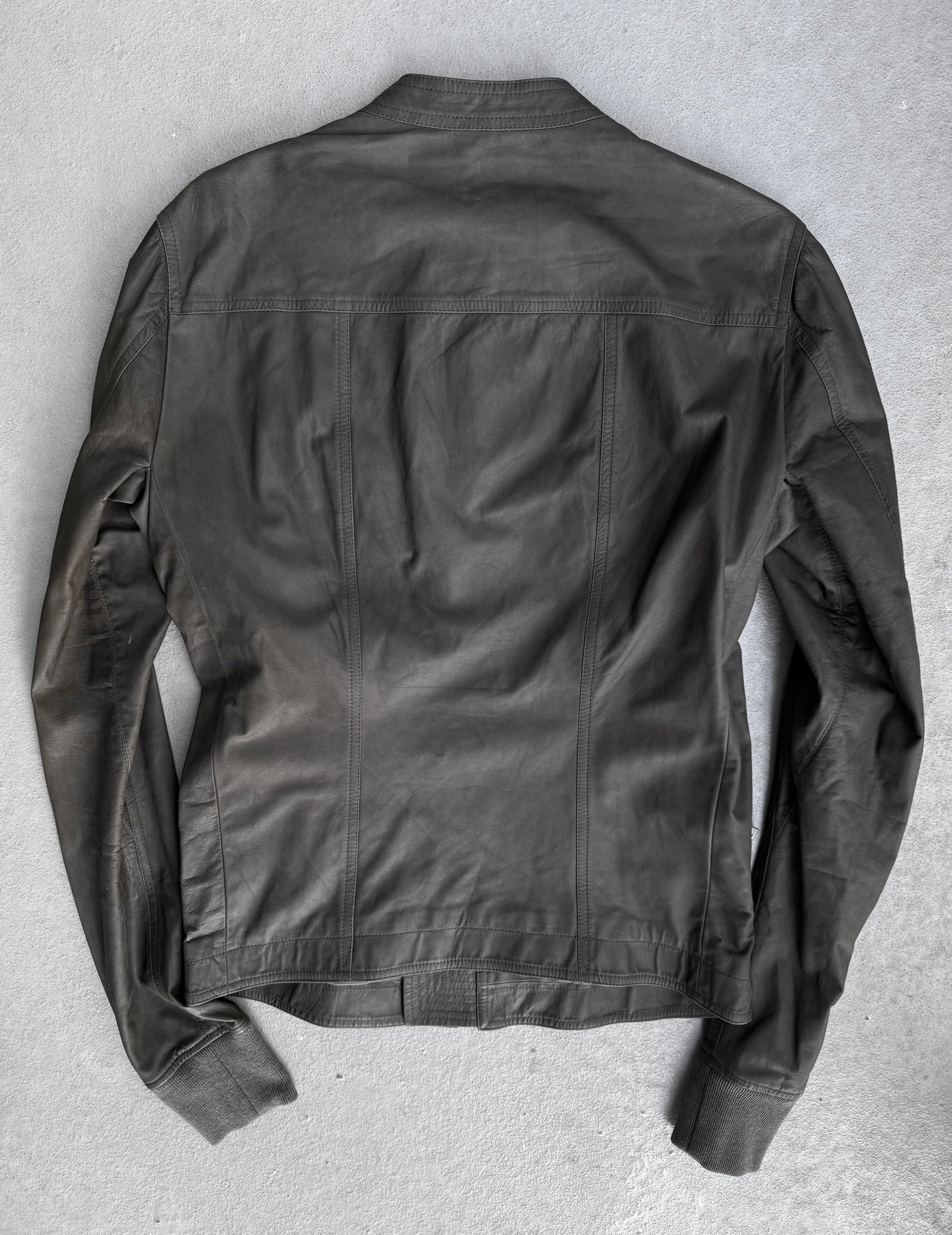 Dark green jacket on a textured gray surface