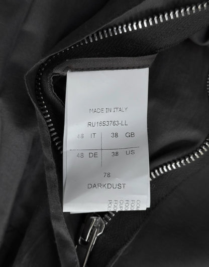 Clothing label on a black jacket with text and size information.