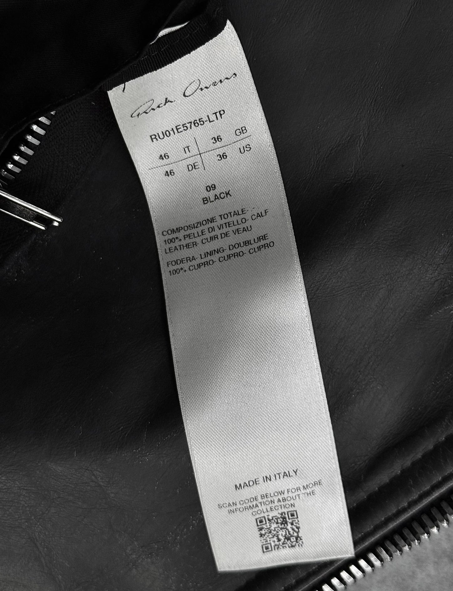 Clothing label with brand name and product details on a dark background