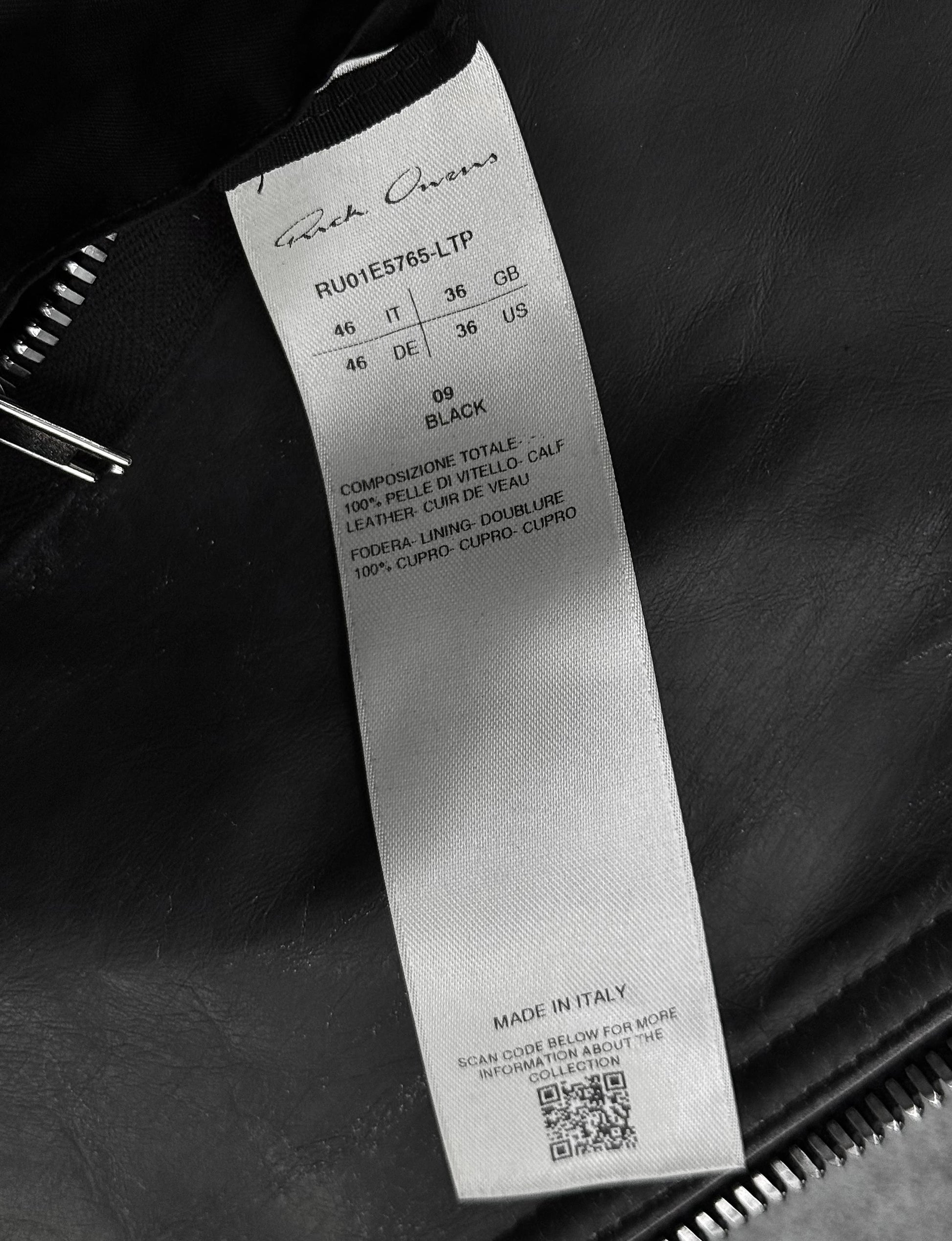 Clothing label with brand name and product details on a dark background