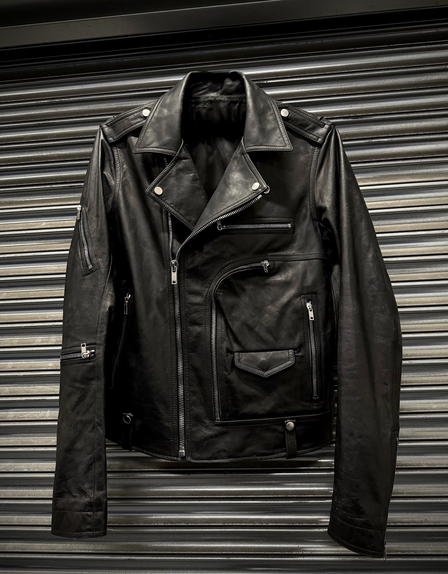 Black leather jacket on a metallic surface