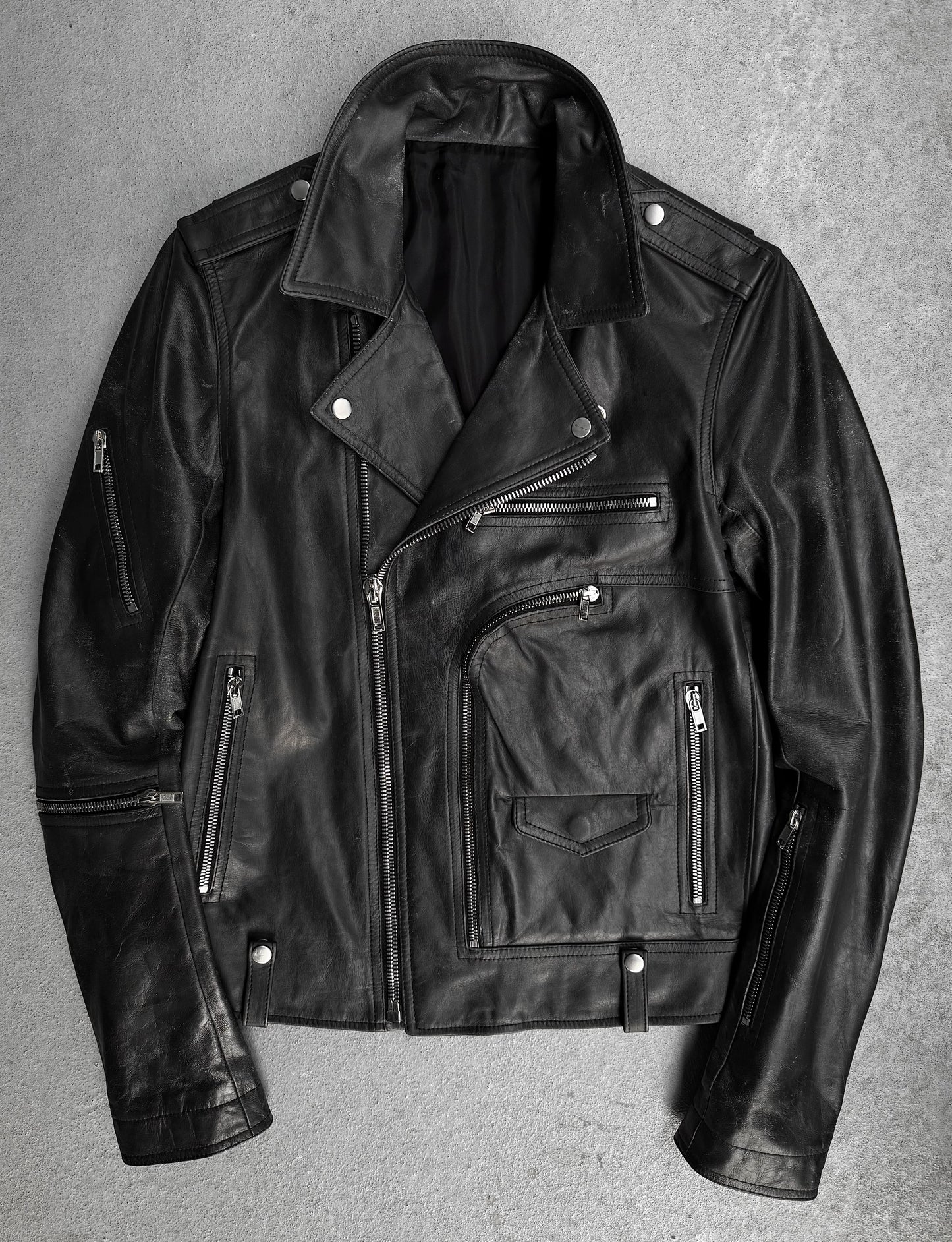 Black leather jacket on a gray background