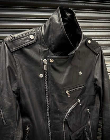 Black leather jacket with zippers against a metallic background