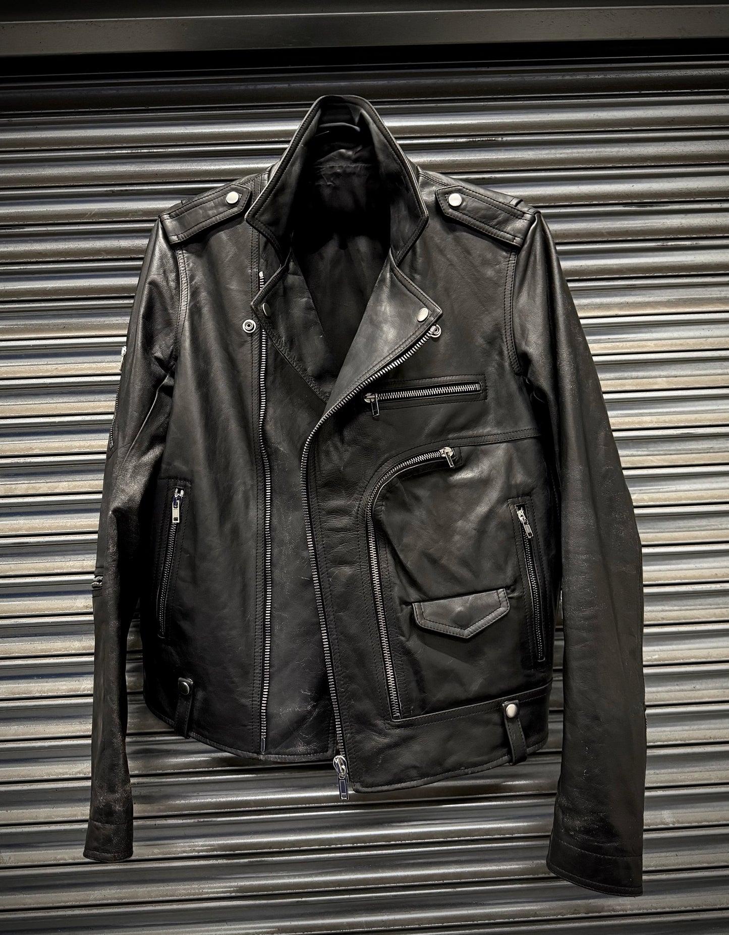 Black leather jacket on a metallic surface