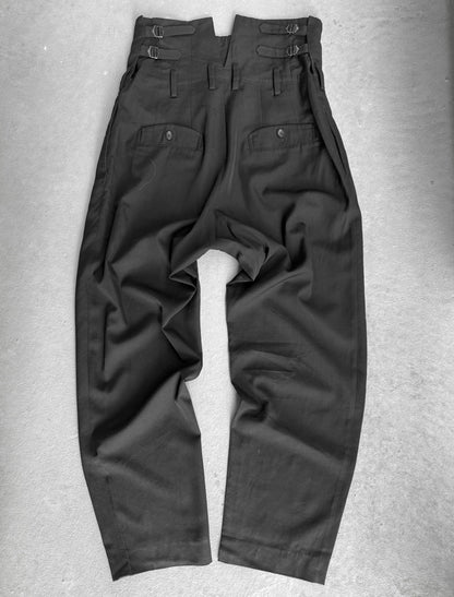 Dark gray pants on a textured gray surface