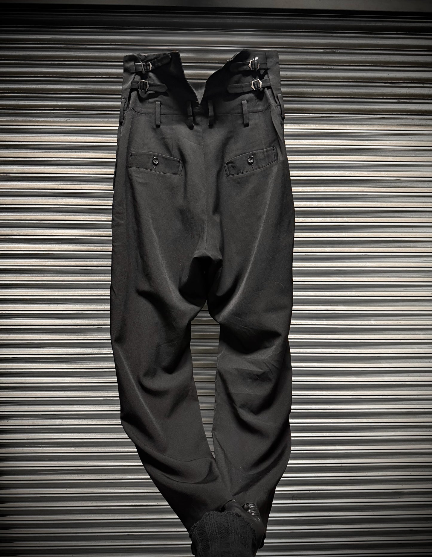 Dark gray pants on a metallic surface