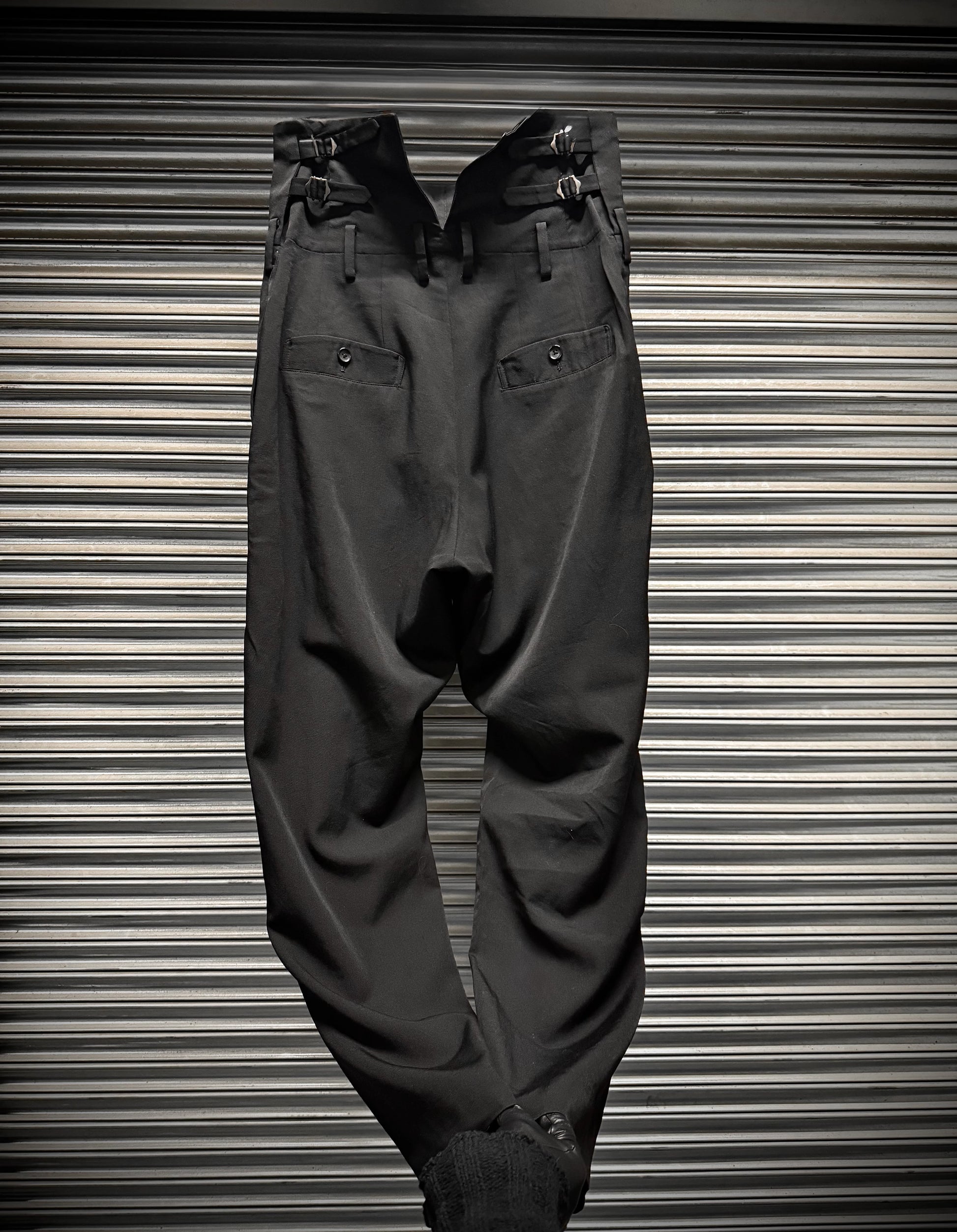 Dark gray pants on a metallic surface