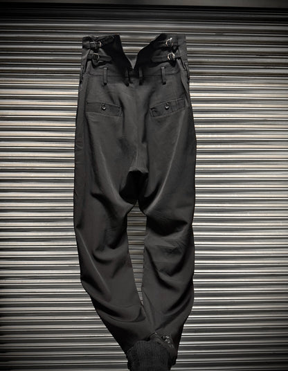 Dark gray pants on a metallic surface