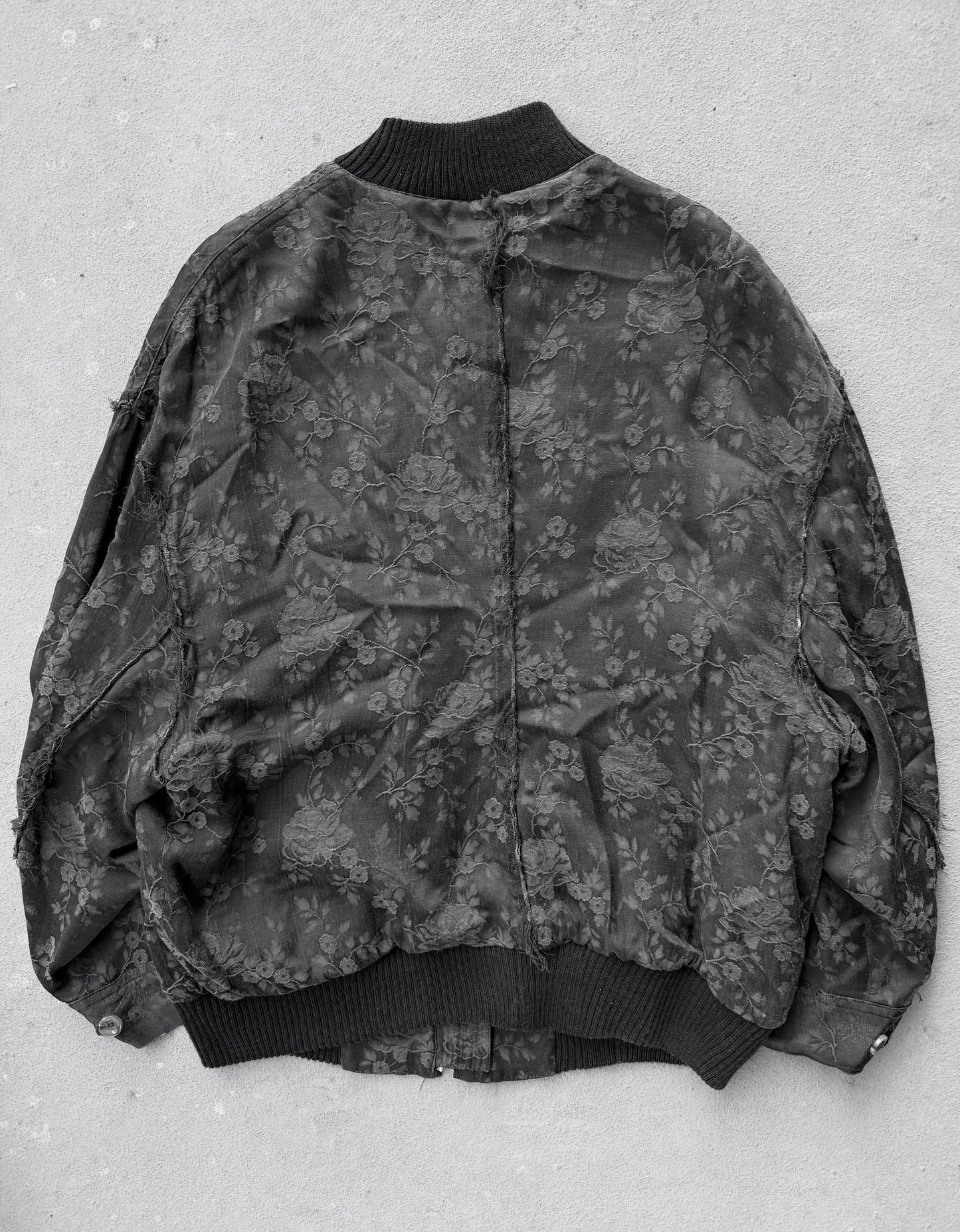 Floral patterned bomber jacket on a light gray background