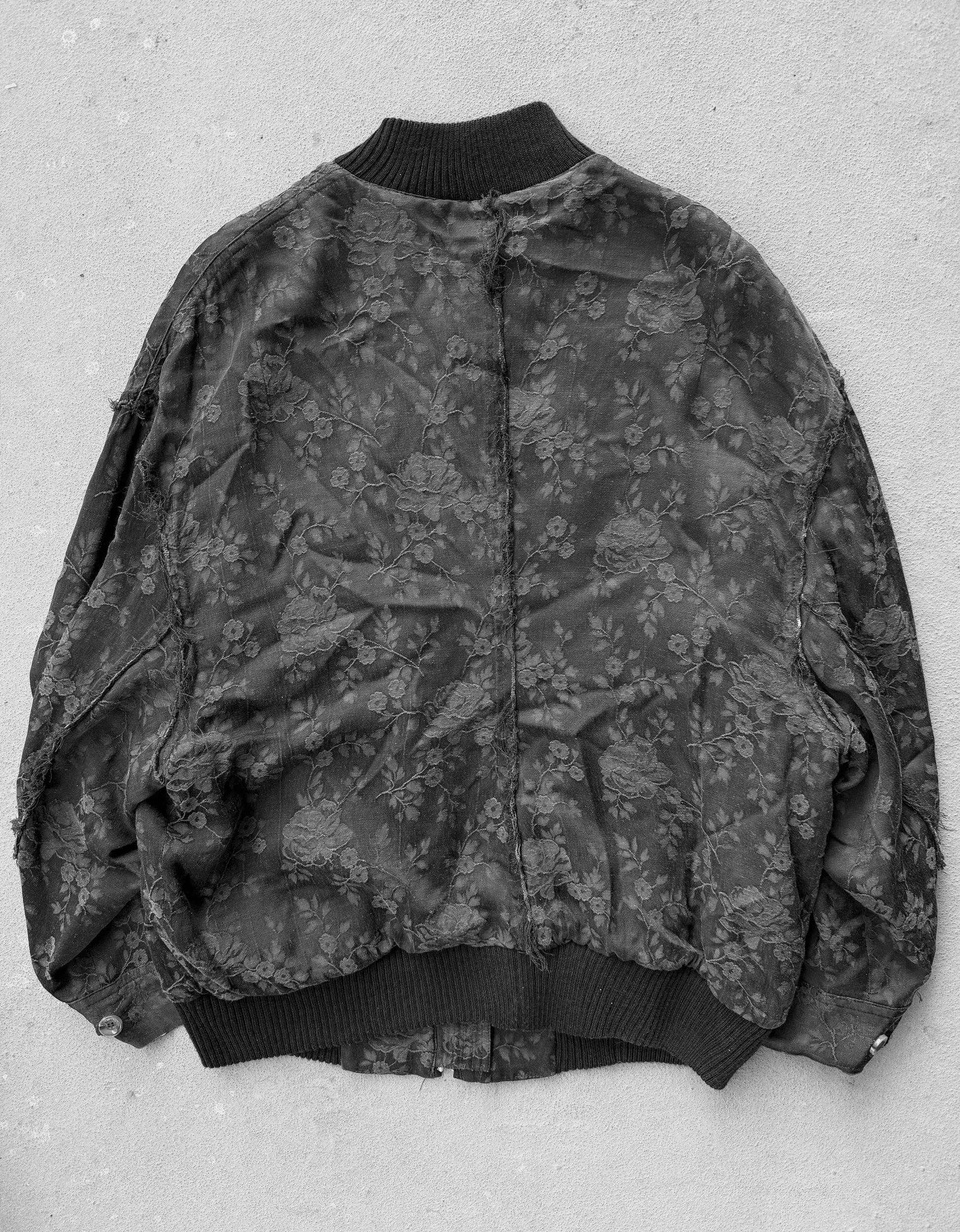 Floral patterned bomber jacket on a light gray background