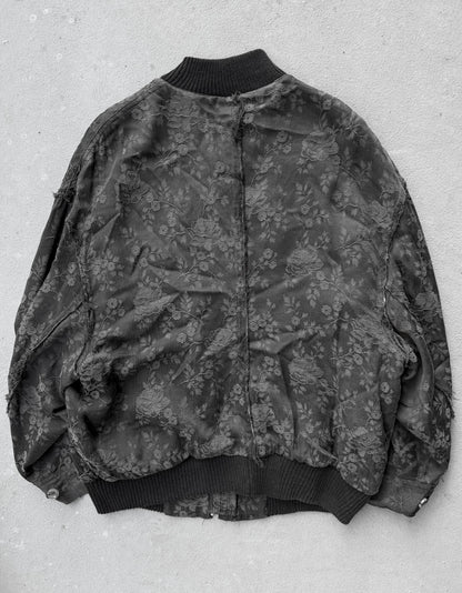 Floral patterned bomber jacket on a light gray background