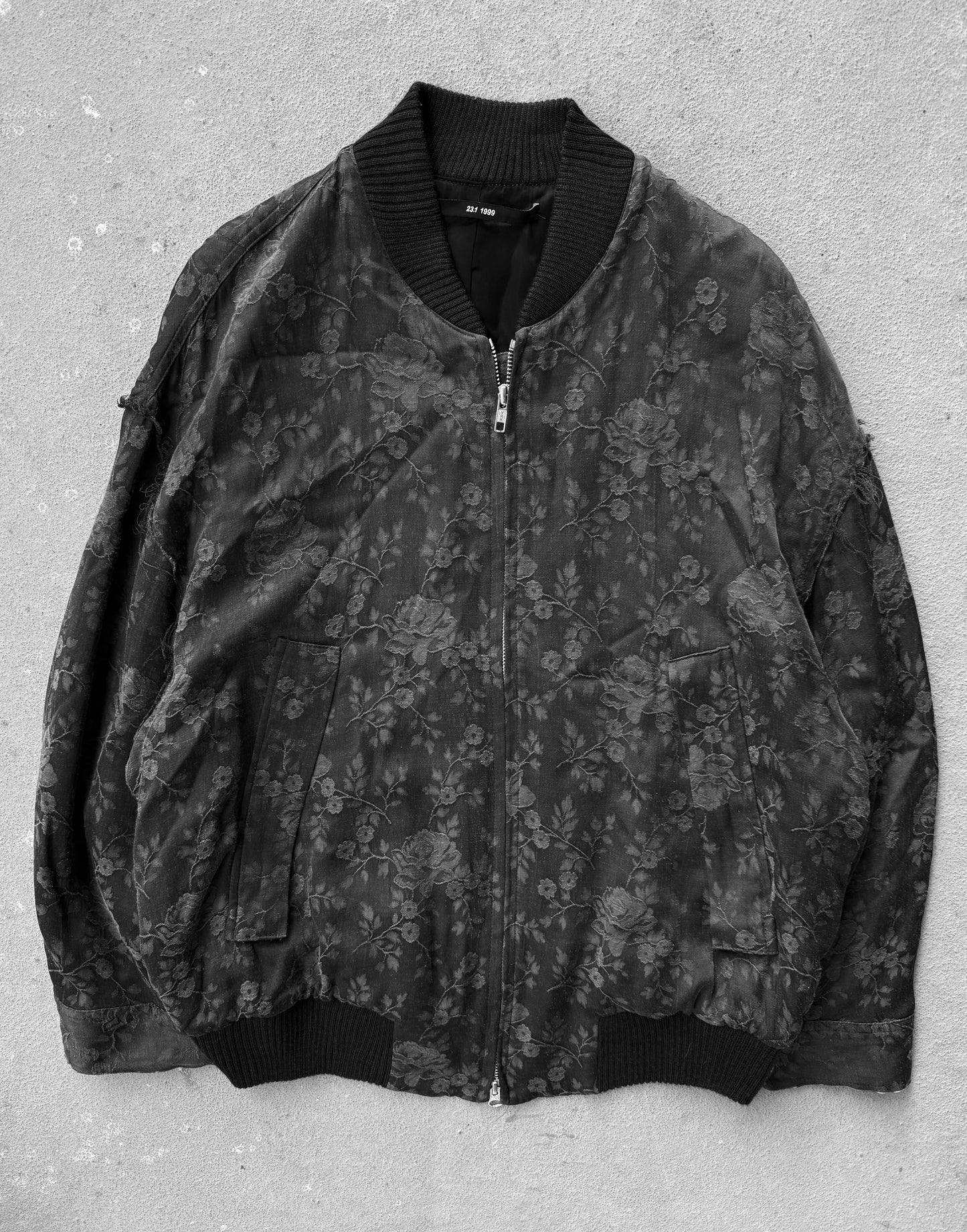 Floral patterned jacket on a textured gray background