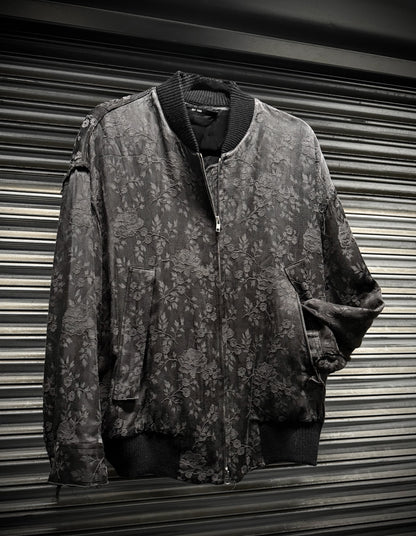 Floral-patterned jacket hanging against a corrugated metal background