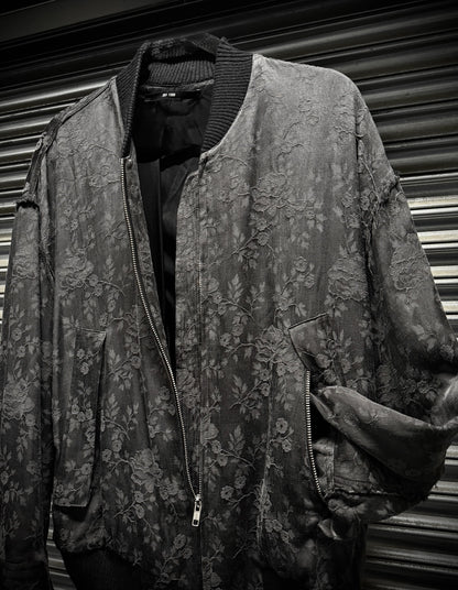Floral patterned jacket on a mannequin against a corrugated metal background