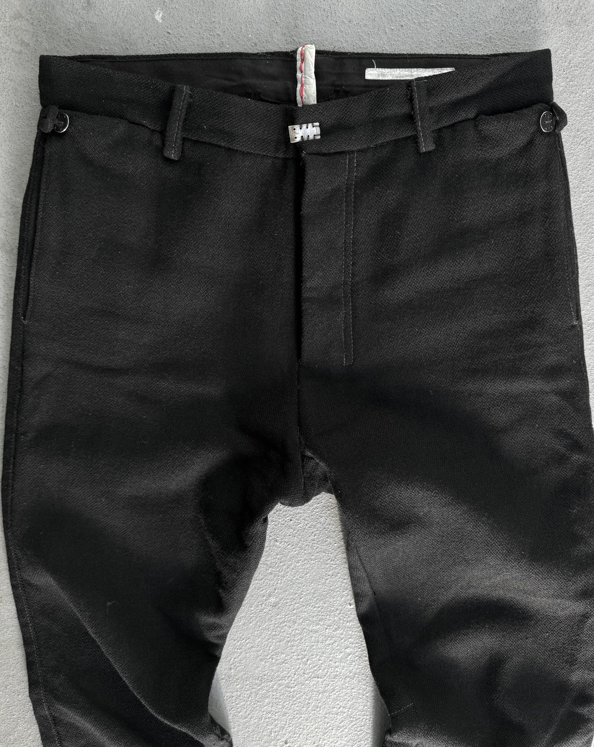 Black pants on a textured gray surface