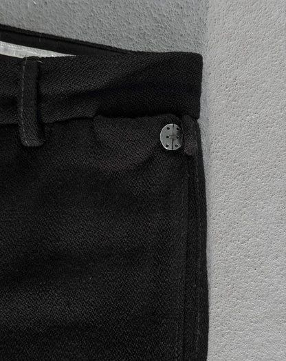 Close-up of a black button on a textured surface