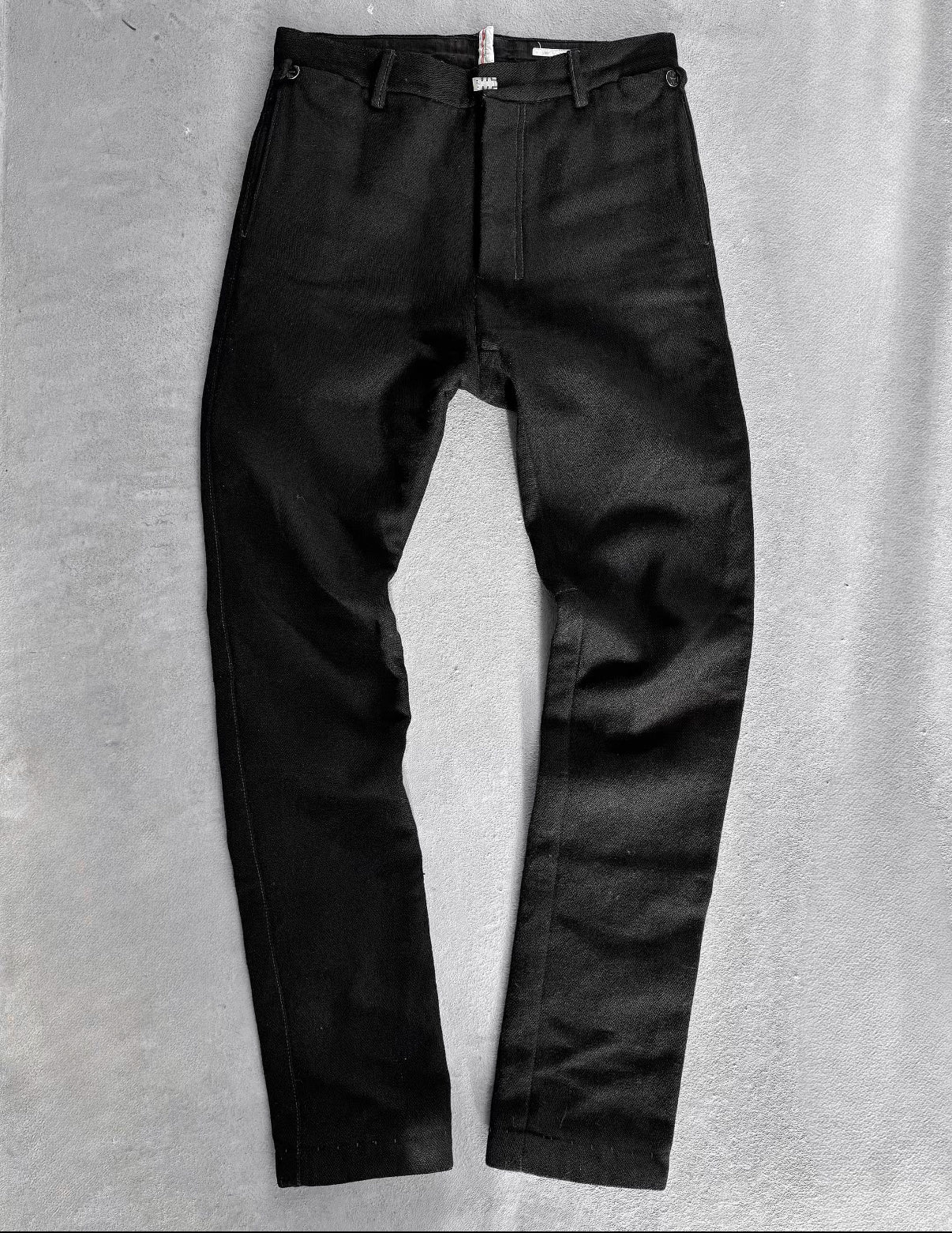 Black pants on a gray textured background