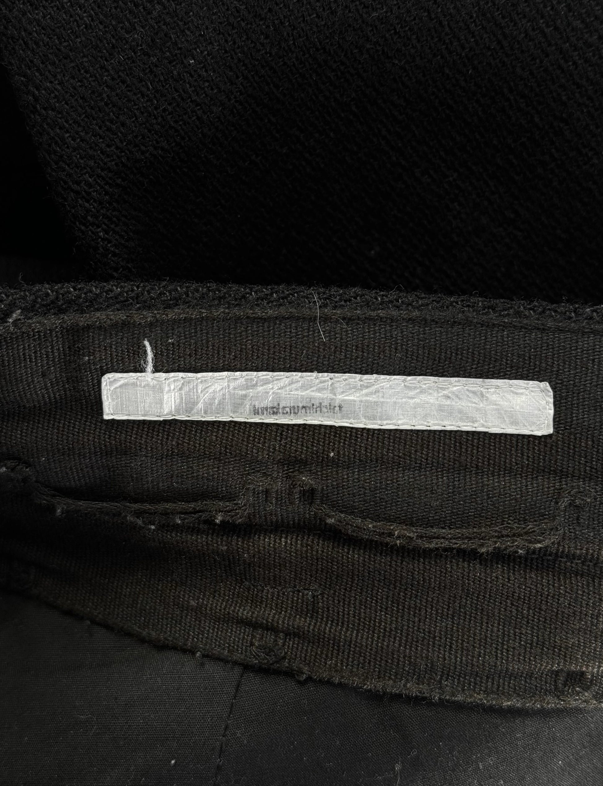 Black fabric with a white label on a dark background