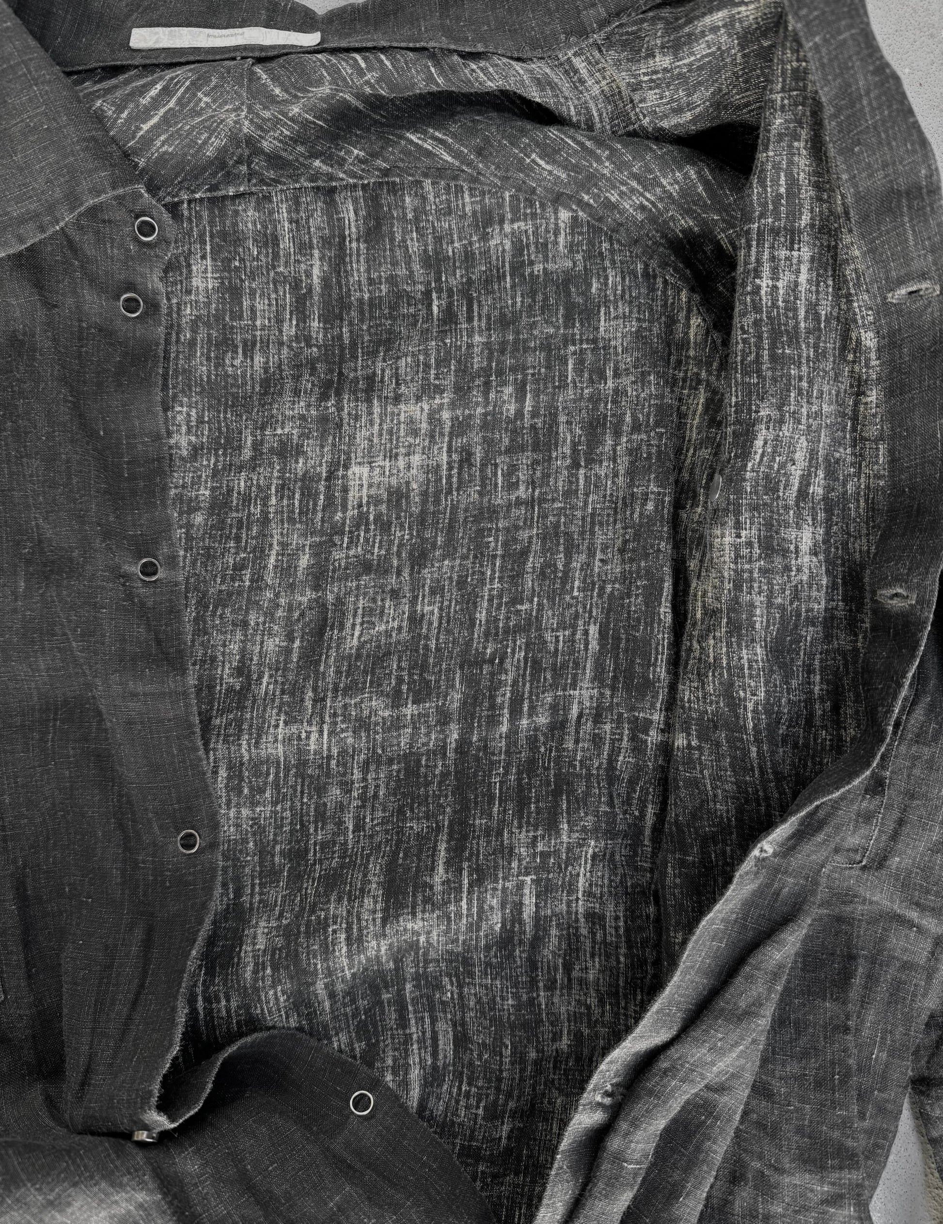 Close-up of a textured fabric with a pattern, possibly denim or cotton.