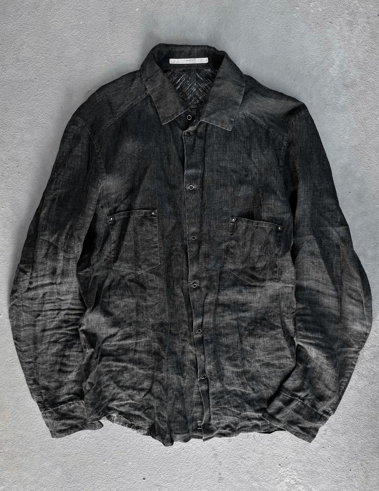 Dark gray shirt on a textured gray background