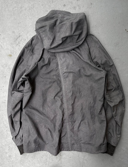 Gray hooded jacket on a textured gray surface