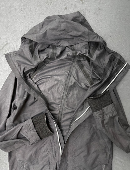Dark gray raincoat with a hood on a light gray background