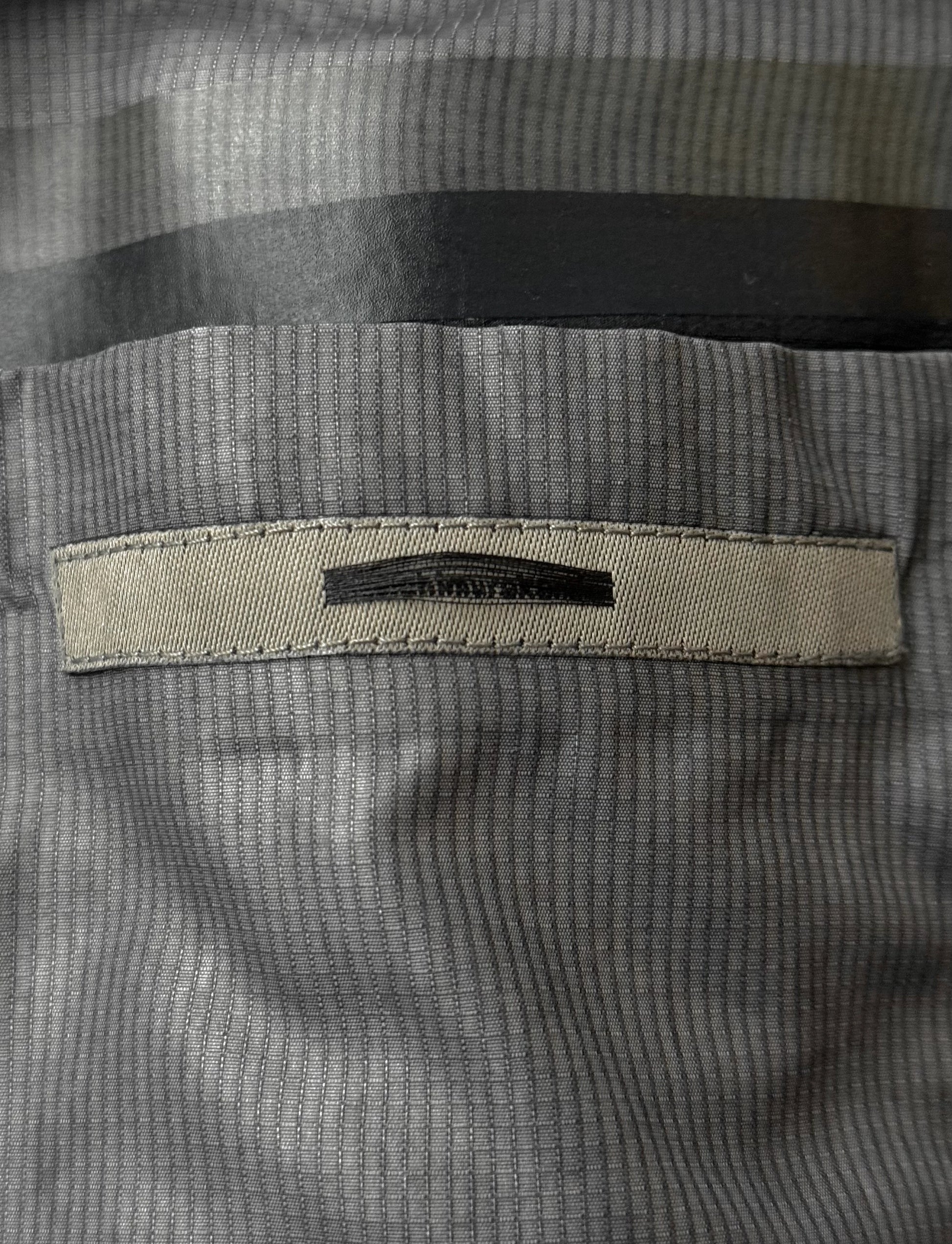 Close-up of a textured fabric with a brand label on a gray background