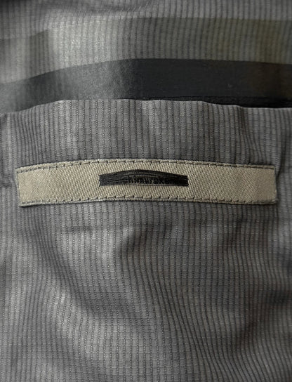 Close-up of a textured fabric with a brand label on a gray background