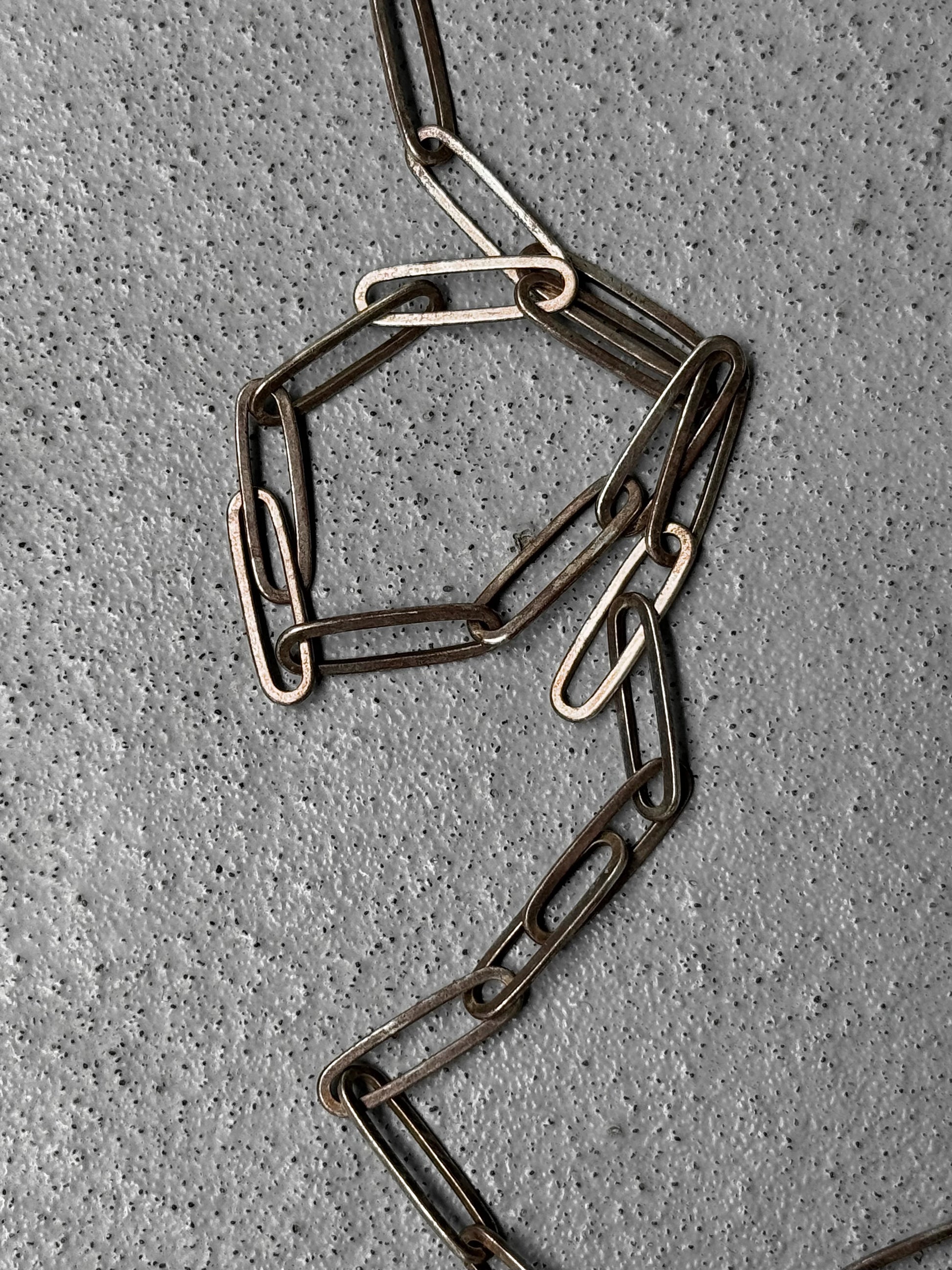 Metal chain on a textured gray surface