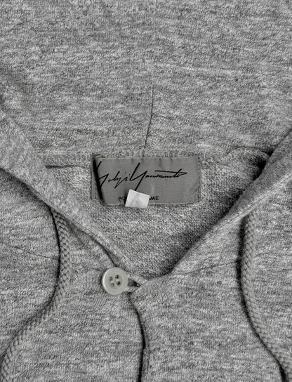 Close-up of a gray garment with a brand label.