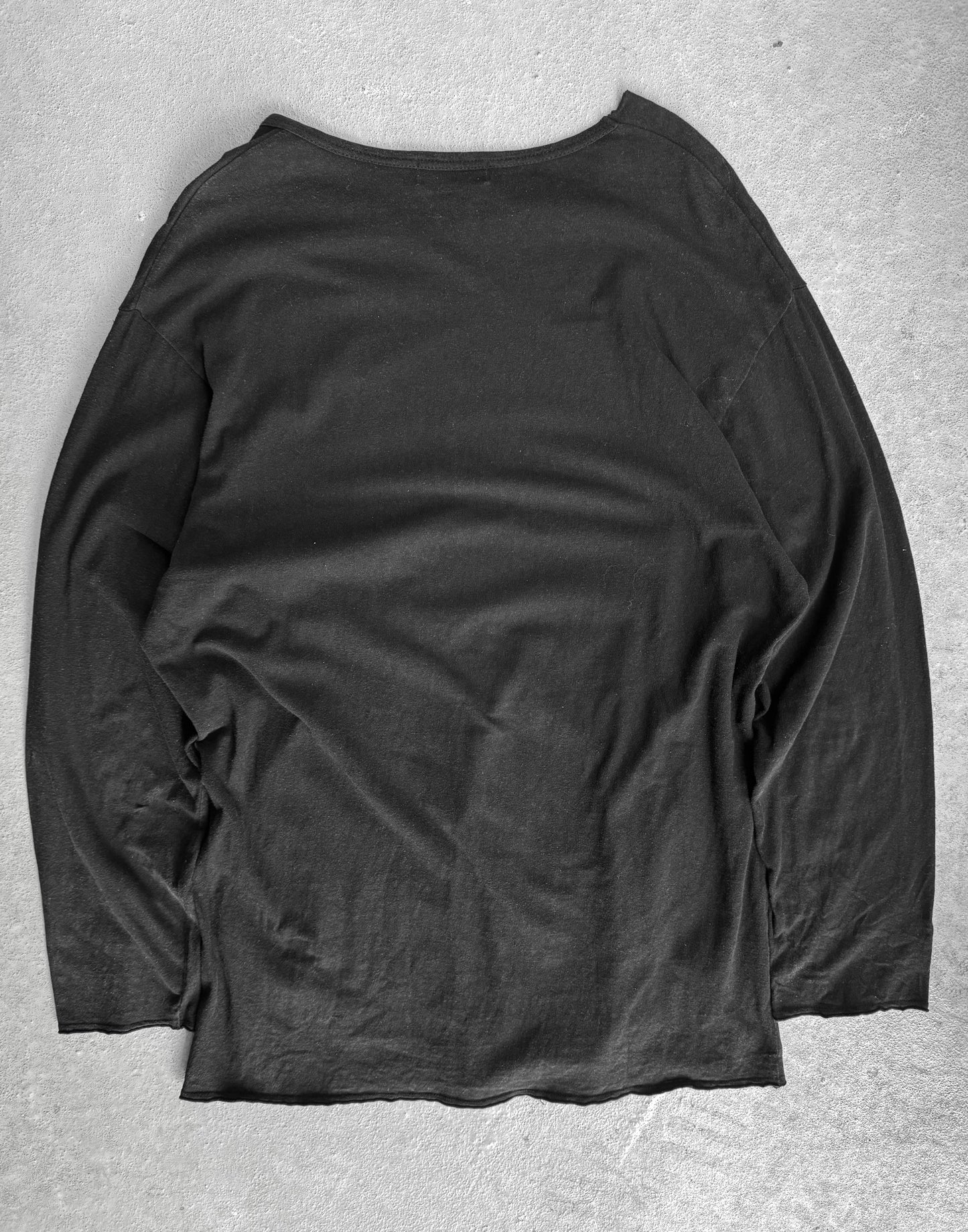 Black long-sleeve shirt on a gray background