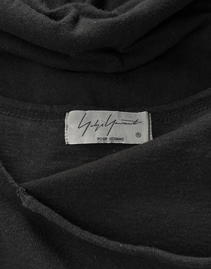 Close-up of a black garment with a label on a dark background