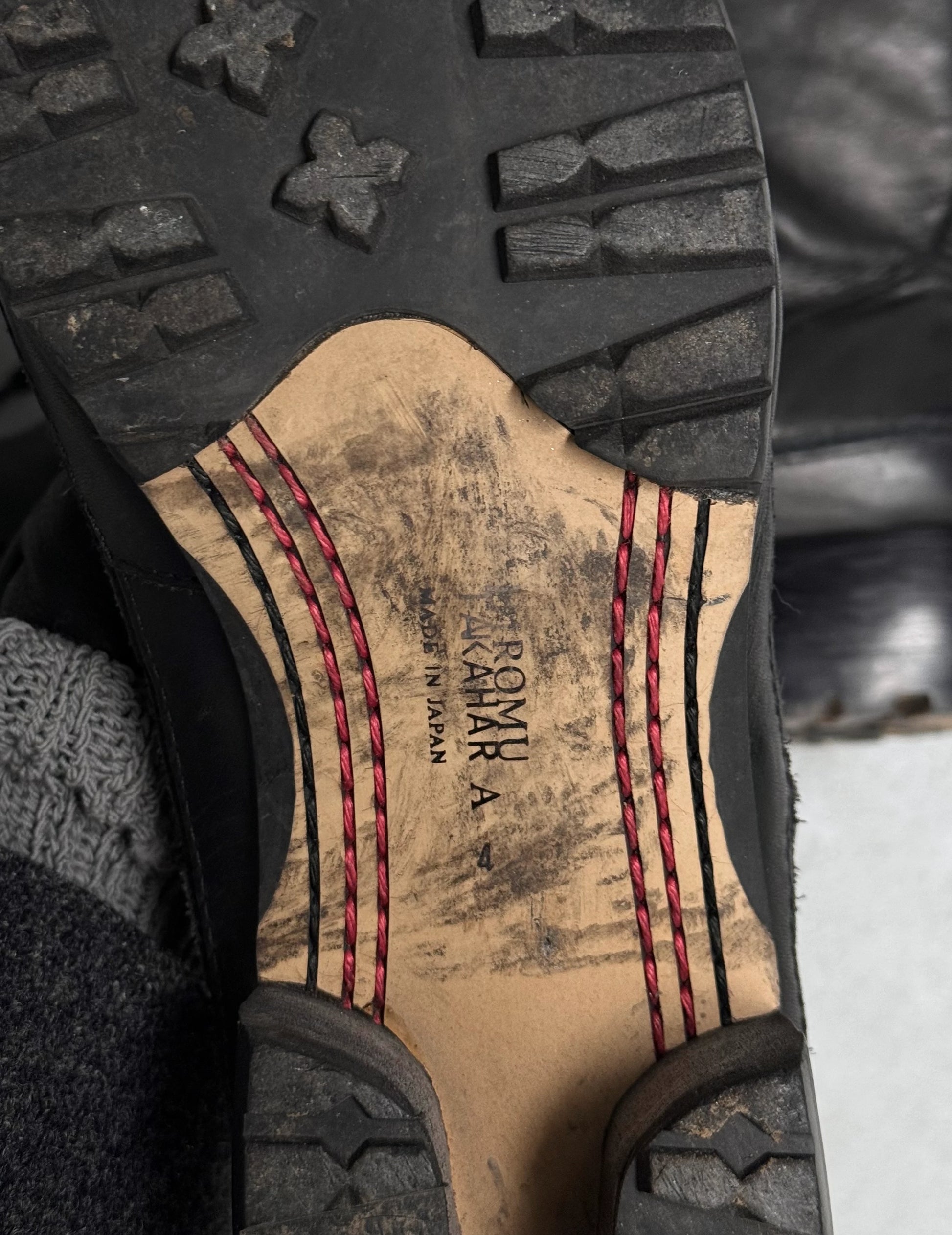 Close-up of a shoe sole with 'Romika' branding and tread pattern.